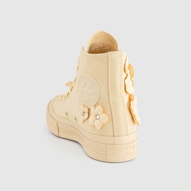 Converse high-top trainer in Golden View, canvas upper with floral appliqu&eacute; details, pearl embellishments, and chunky platform sole, rear view.