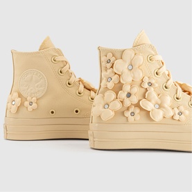 Converse Chuck Taylor All Star platform high-top trainers in golden yellow with 3D floral appliqu&eacute;s and tone-on-tone sole