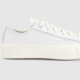 Converse Chuck Taylor platform low-top trainer in vintage white perforated leather with chunky cream sole and lace-up front.