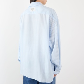 Model wearing Acne blue stripe lyocell shirt, rear view showing relaxed fit, long sleeves and small logo patch at back yoke