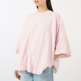 Model wearing Acne white oversized T-shirt in cotton-hemp blend, featuring drop shoulders and wide sleeves, styled with light blue jeans