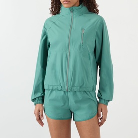 Model wearing Adanola Eucalyptus Green zip-up jacket with elasticated hem, paired with matching shorts.