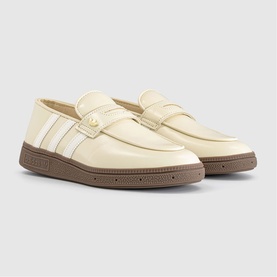 Cream leather loafers with white stripe detail, gold-tone logo badge, and brown rubber sole