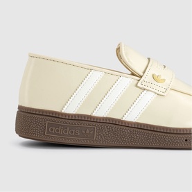 Adidas cream patent leather loafer trainer with white three stripes, gold logo detail, and brown gum sole