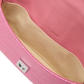 Jacquemus Le Bambino Chaine Shoulder Bag in light pink leather, open flap showing cream interior lining and silver-toned logo plaque