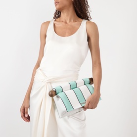 Model carrying Jacquemus La Pochette Rond Carr&eacute; Clutch in Print Stripes White/Mint, with wooden circle and square closure ends, styled with white