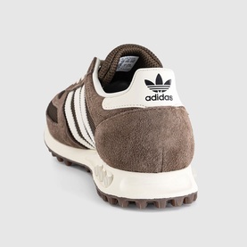 Adidas trainer in earth strata brown, white three-stripe detail, suede upper, cream midsole and heel tab, shown from rear angle.