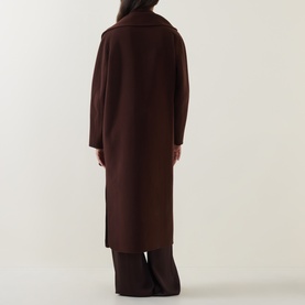 Model wearing Luisa Cerano dark brown longline coat, shown from behind, styled with wide-leg trousers.