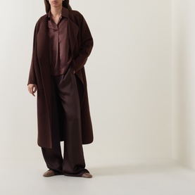 Model wearing Luisa Cerano dark brown long coat, styled with matching brown wide-leg trousers and satin shirt.
