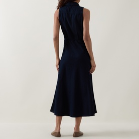 Model wearing Luisa Cerano Dark Blue Denim Shirt Dress, sleeveless midi with flared skirt and tie belt, back view.