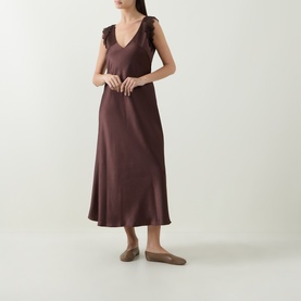 Model wearing Luisa Cerano dark brown satin midi dress with ruffle shoulder straps, styled with taupe ballet flats.