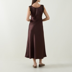 Model wearing Luisa Cerano dark brown satin midi dress with ruffle shoulders and flared skirt, shown from the back.