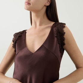 Model wearing Luisa Cerano dark brown satin dress with V-neckline and lace trim shoulder detail, close-up view.