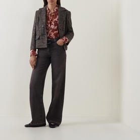 Model wearing Luisa Cerano wide-leg dark grey jeans in cotton, styled with a floral blouse and grey tweed blazer.