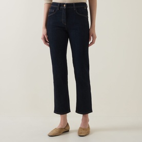 Model wearing Luisa Cerano Straight Leg Jeans in dark blue with tobacco stitching, styled with gold flat shoes.