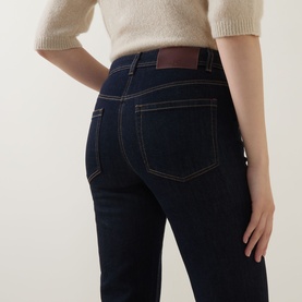 Model wearing Luisa Cerano Straight Leg Jeans in dark blue with tobacco stitching and logo badge, styled with a cream knit top.