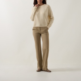 Model wearing Luisa Cerano Fine Knit Sweater in yellow with crew neck and raglan sleeves, styled with taupe tailored trousers