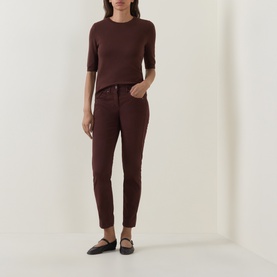 Model wearing Luisa Cerano Dark Brown knit top with elbow-length sleeves, styled with matching brown trousers and black flat shoes.