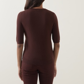 Model wearing Luisa Cerano dark brown fine knit top with elbow-length sleeves, shot from behind, styled with matching trousers.