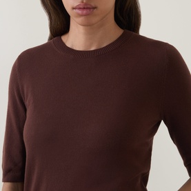 Model wearing Luisa Cerano dark brown fine knit top with crew neck and elbow-length sleeves.