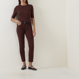 Model wearing Luisa Cerano dark brown short-sleeve knit top, styled with matching slim trousers, black belt and black flat shoes.