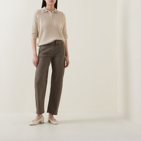 Model wearing Luisa Cerano Embellished Knitted Polo Sweater in Ginger with khaki tapered trousers and flat white shoes.