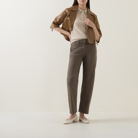 Model wearing Luisa Cerano Embellished Knitted Polo Sweater in Ginger, styled with brown trousers, a cropped jacket, and cream flat shoes.