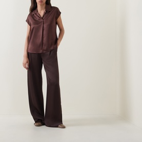 Model wearing Luisa Cerano dark brown 100% silk short-sleeve shirt with wide-leg trousers in matching tone.
