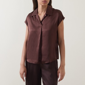 Model wearing Luisa Cerano dark brown silk shirt with camp collar and short sleeves, styled with matching wide-leg trousers.