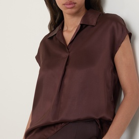 Model wearing Luisa Cerano dark brown 100% silk sleeveless shirt with spread collar and concealed button placket.