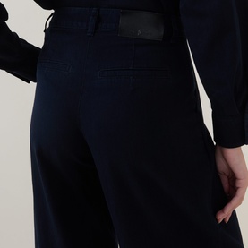 Model wearing Luisa Cerano dark blue cotton trousers, close-up of waistband and wide-leg silhouette, styled with matching navy jacket