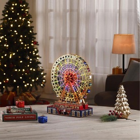 Music Box World RGB Musical Ferris Wheel Decoration 31cm, multi-coloured LED lit ferris wheel ornament styled in a festive living room setting