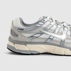Nike P-6000 trainers in Light Bone Sail Pale Ivory, close-up detail of silver Swoosh logo, mesh upper and chunky cream sole