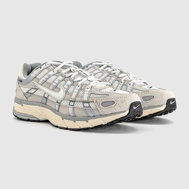 Nike P-6000 trainers in Light Bone and Sail, suede and mesh upper, chunky cream midsole, grey accents, pair angled view