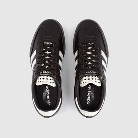 Adidas trainers in black and white leather with three-stripe detail, white rubber cupsole, overhead flat-lay view