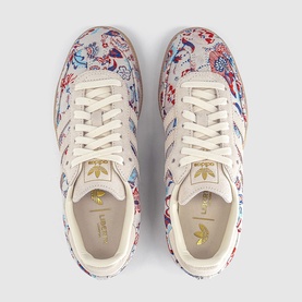 Adidas trainers in Liberty Off White Gum, floral print upper, gold branding, cream laces, overhead flat lay view
