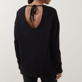 Model wearing Sweaty Betty After Class Open Back Tie Sweatshirt in black, showing open back with tie detail, long sleeves