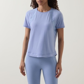 Model wearing Sweaty Betty Laguna Blue T-shirt with short sleeves and relaxed fit, styled with matching leggings.