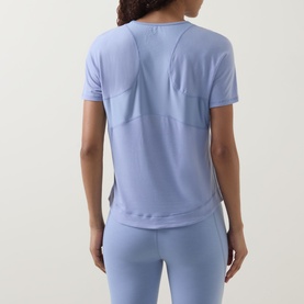 Model wearing Sweaty Betty T-Shirt in Laguna Blue, back view, with matching leggings, short sleeves and mesh panel detail.