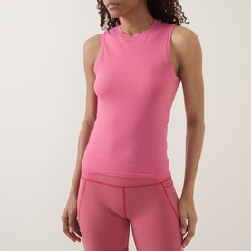 Model wearing Sweaty Betty tank in Crimson Red Drop Needle Stripe, styled with matching leggings, sleeveless ribbed design with mock neck.