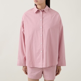 Model wearing Sweaty Betty Summer Stripe Shirt in Pink White Stripe, styled with pink shorts