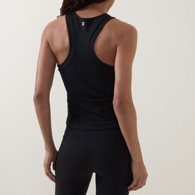 Model wearing Sweaty Betty black racerback tank top, shown from behind, paired with black leggings