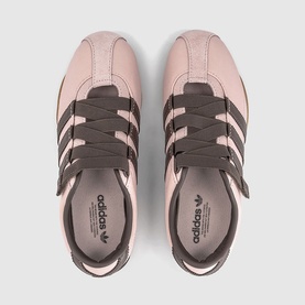 Adidas trainers in sandy pink and earth strata, overhead flat lay showing three-stripe detail and chunky dark laces
