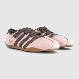 Adidas trainers in Sandy Pink with Earth Strata three stripes, gold branding, lace-up fastening, and gum sole