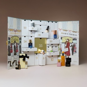 Brown Thomas Beauty Advent Calendar with illustrated facade design, numbered doors, and miniature beauty products displayed in front