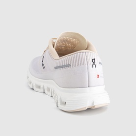 On Running trainer in sand and white, rear three-quarter view showing CloudTec sole, knit upper and heel tab detail