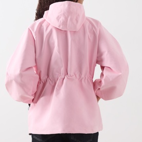 Model wearing Damson Madder pink hooded jacket, rear view, elasticated waist, voluminous sleeves, black trousers visible