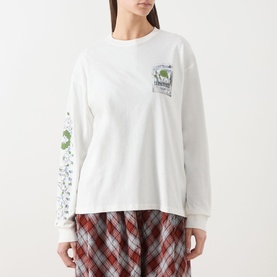 Model wearing Damson Madder Plant Patch Pals T-Shirt in white with graphic sleeve print, styled with a red plaid skirt.