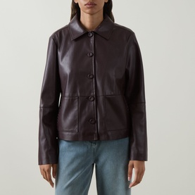 Model wearing Elena Miro jacket in must, faux leather finish, button-front with patch pockets, styled with light blue jeans.