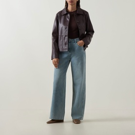 Model wearing Elena Miro Wide-Leg Jeans in light blue, high-rise with tobacco stitching, styled with a dark cropped leather jacket.
